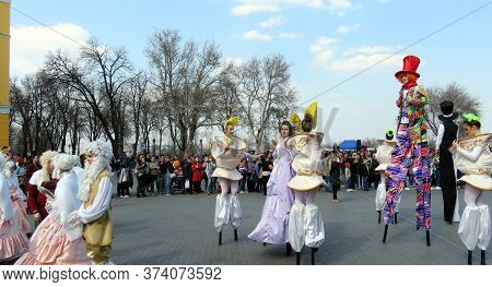 Odessa, Ukraine - 04 01 2019: Costumed Court Princes And Princesses With Bright Clowns Acting On Sti