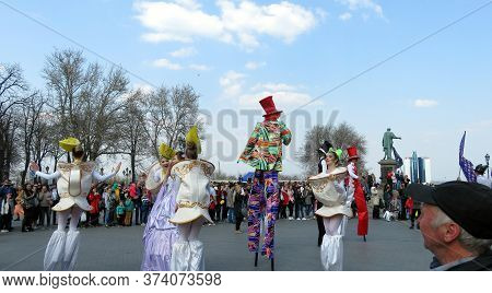 Odessa, Ukraine - 04 01 2019: Court Princesses With Bright Clowns Acting On Sticks In Front Of A Cro
