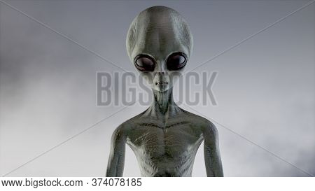 Scary Gray Alien Walks And Looks Blinking On A Dark Smoky Background. Ufo Futuristic Concept. 3d Ren