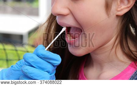 Doctor Performs A Medical Swab To The Girl Who Seems To Have No Symptoms But Could Be A Healthy Carr