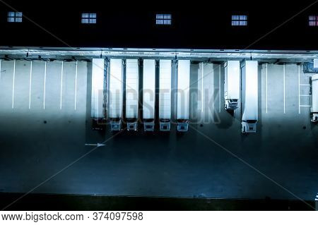 Night Loading Dock At A Warehouse. Modern Logistics Center. Docking Stations Of A Distribution Cente