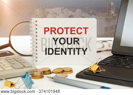 Desktop With Documents, Calculator And Notebook. On A Blockboard Inscription Protect Your Identity