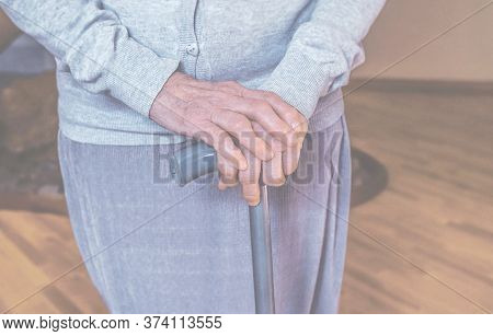 Old Wrinkled Hands On Walking Frame. Hands Of A Standing Senior Woman Leaning On A Rollator. Pension