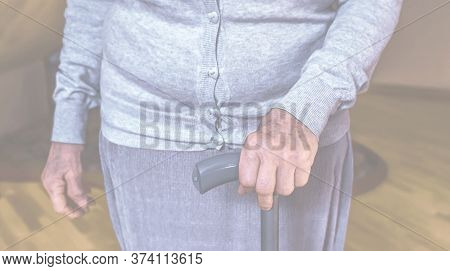 Old Wrinkled Hands On Walking Frame. Hands Of A Standing Senior Woman Leaning On A Rollator. Pension