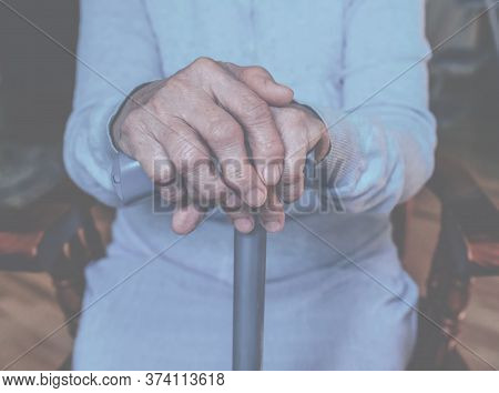 Old Wrinkled Hands On Walking Frame. Hands Of A Standing Senior Woman Leaning On A Rollator. Pension