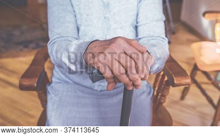 Old Wrinkled Hands On Walking Frame. Hands Of A Standing Senior Woman Leaning On A Rollator. Pension
