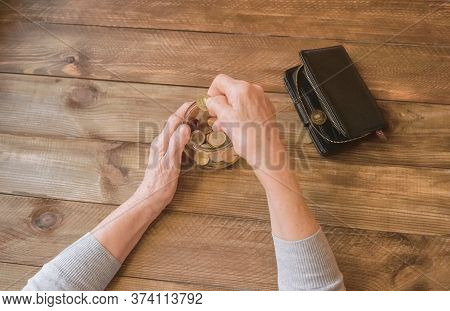 Old Wrinkled Hands On Walking Frame. Hands Of A Standing Senior Woman Leaning On A Rollator. Pension
