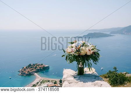 Bridal Bouquet Of White And Pink Roses, Peonies, Hortense Branches Of Eucalypt Tree, And White Ribbo