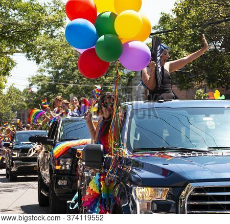 Babylon, New York, Usa - 28 June 2020: People In Trucks And Cars With Colorful Bolloons And Decorati