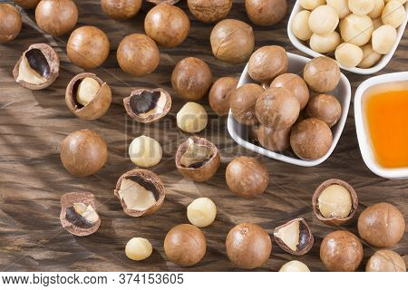 Organic Macadamia Nut On Wooden Table - Macadamia Integrifolia
