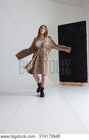 Attractive Caucasian Skinny Girl With Long Hair Posing On White Cyclorama. Beauty Portrait, Model Te