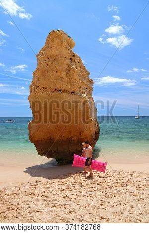 Algarve, Portugal - May 31, 2018: Beachgoers Visit Marinha Beach In Algarve Region, Portugal. Coasta