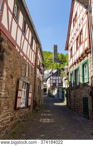 Narrow Paved Road In Monreal, Germany With Löwenburg In The Background