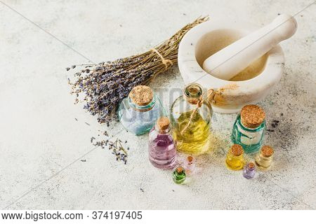 Aromatic Oils In Glass Bottles, Aromatic Salts, Marble Mortar And Dry Lavender. Concept Natural Ogra