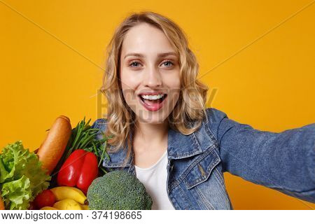 Close Up Of Young Woman In Denim Clothes Isolated On Orange Background. Delivery Service From Shop O