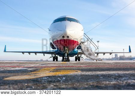 Front View Of The Passenger Regional Jet On The Winter Airport Apron