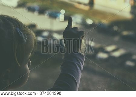 Girl Looks Lonely Through Window By Putting Her Hands On Window Sill