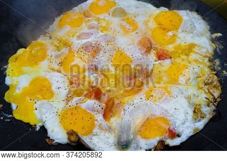 Fried Eggs With Tomatoes On Metal Plate. Saj With Food On Grill.