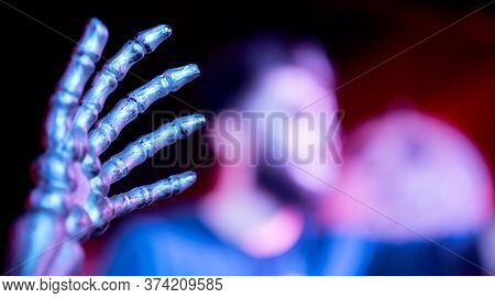 The Hand Of The Skeleton In The Foreground In The Nightclub Blurred Man In The Background