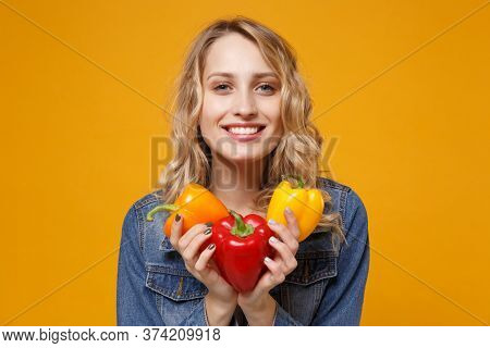 Smiling Young Woman In Denim Clothes Isolated On Yellow Orange Background In Studio. Proper Nutritio