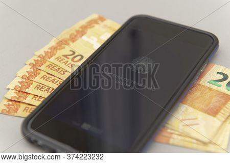 June 27, 2020, Brazil: Close Up Of Cellphone And Real Banknotes - Brazilian Work Document And Social