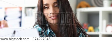 Musician Looks At Note For Guitar On Music Stand. Training In Reading From Sheet Notes For Quick Mem