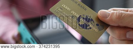 Man Holds Credit Card With Paypass Technology. Overdraft Debit Card. Making Transfers. Portable Term