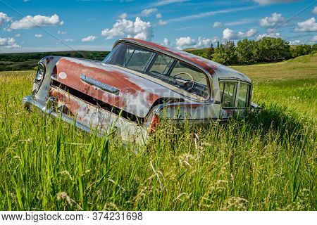 Wymark, Sk/canada- June 28, 2020:  Abandoned Vintage Nash Rambler Blue Sedan In The Tall Grass On A 