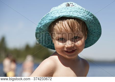 Umea, Norrland Sweden - June 20, 2020: A Happy Little Guy Who Has Just Bathed In The Lake