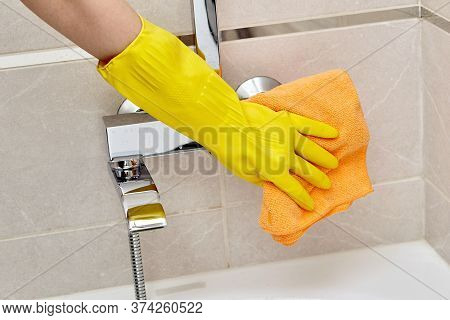 Professional Housekeeping. Wipe The Faucet In The Bathroom With A Dry Towel.