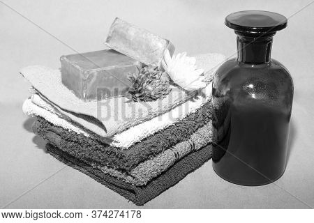 Soap Bar On Top Of Facecloths Off Various Shades With Flowers And Bottle