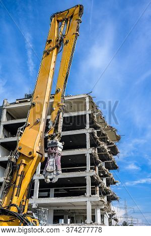 Building House Demolition Site Excavator With Hydraulic Crasher Machine And Yellow Container