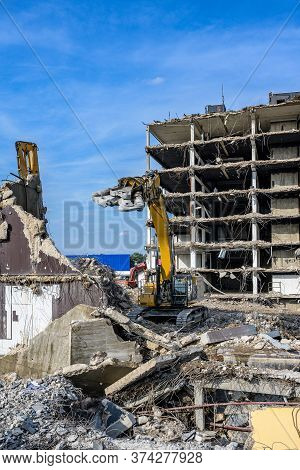Building House Demolition Site Excavator With Hydraulic Crasher Machine And Yellow Container