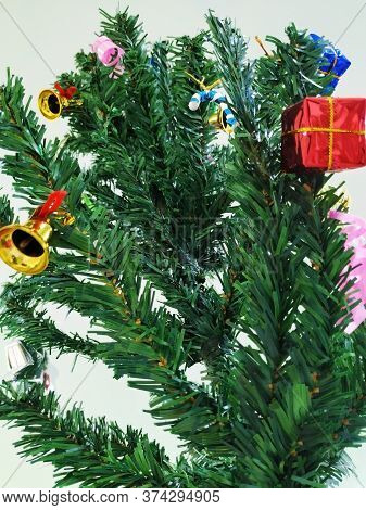 Beautiful View Of Christmas Tree Decoration With Bell, Gift Box And Star. Done At Entrance Of Columb