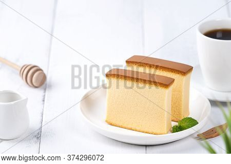 Castella (kasutera) - Beautiful Delicious Japanese Sliced Sponge Cake Food On White Plate Over Rusti