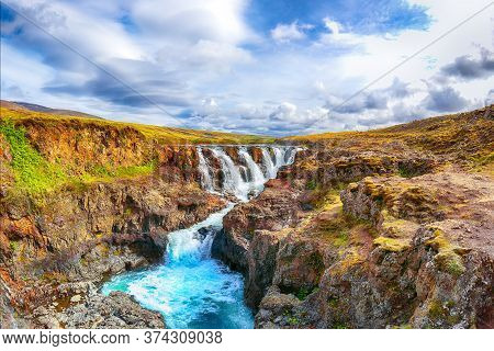 Charming View Of  Kolufossar Waterfall At Summer Sunny Day.  Popular Tourist Travel Destination In I
