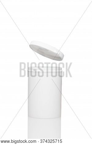 White Blank Opened Plastic Container Stay On The Surface. Levitating Lid Is Jump Up. Isolated On Whi