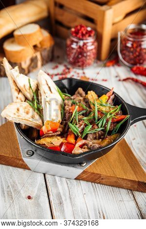 Side View On Mexican Dish Fajitos With Beef Vegetables And Pita In A Pan, Vertical