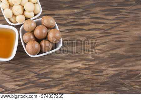 Organic Macadamia Nut On Wooden Table - Macadamia Integrifolia