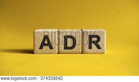 Adr Text On A Yellow Background On Wooden Cubes