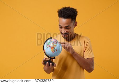 Smiling Young African American Guy In Casual T-shirt Posing Isolated On Yellow Orange Wall Backgroun