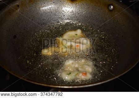 South Indian Cuisine - Vada Or Medu Vadai Frying In Coconut Oil. Very Popular South Indian Snack.
