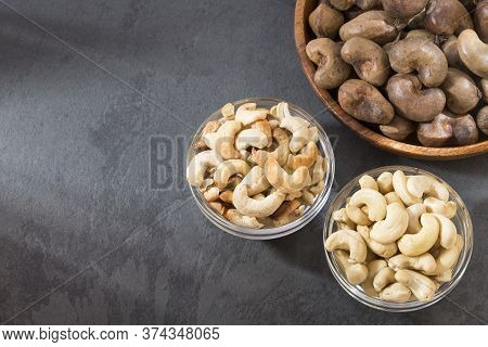 Natural And Roasted Cashew Nut On Wooden Background - Anacardium Occidentale