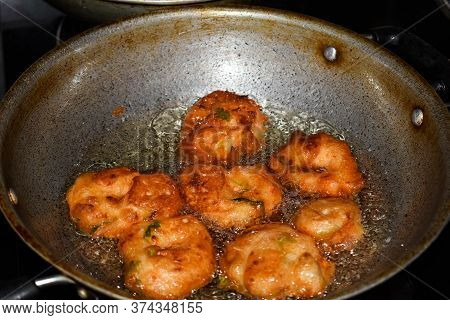 South Indian Cuisine - Vada Or Medu Vadai Frying In Coconut Oil. Very Popular South Indian Snack.
