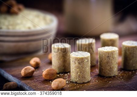 Sweet Pieces Peanut Butter On A Rustic Table, Called Brazilian Paçoca.