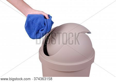 Hand Push A Trash Into Big Brown Trashcan Or Waste Bin On White Background.