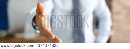 Close-up Of Stylish Businessman Shake Hand. Office Worker Wearing Trendy Costume And Tie. Man In Pre