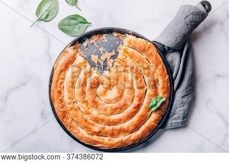 Filo Spinach And Feta Twist Pie In The Iron Pan After Oven. Authentic Greek Bakery. With Spinach, Mi