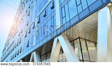 Combination Of Metal And Glass Wall Material. Steel Facade On Columns. Abstract Modern Architecture.