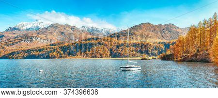 Picturesque Autumn Views Of Sils Lake (silsersee) With Small White Yacht. Colorful Autumn Scene Of S